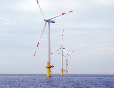 Three windmills at sea
