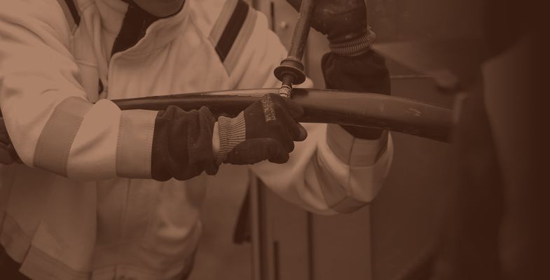 Installer using rip cord to open sheath on medium voltage cable